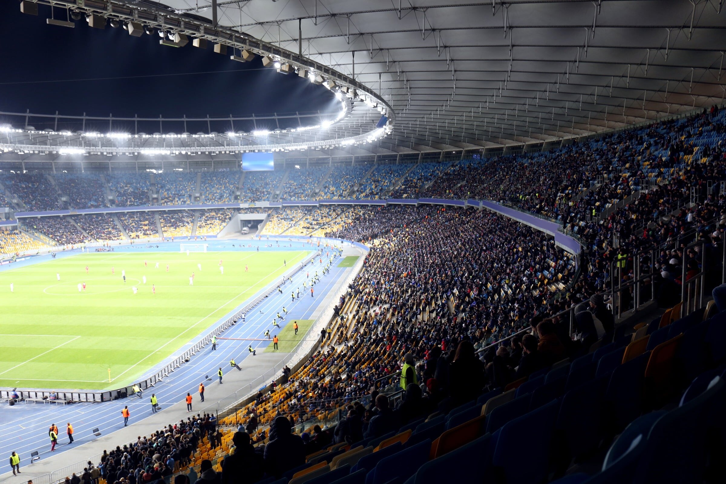 A full football stadium under the floodlights